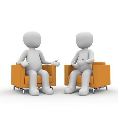 Grafik: Zwei Personen sitzen zusammen und reden miteinander.